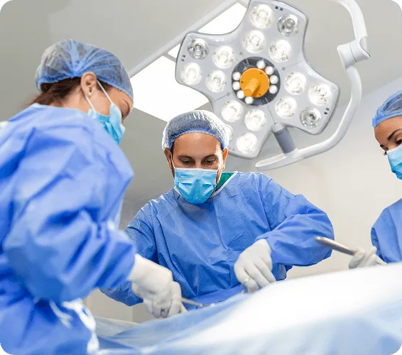 ambulatory-surgical-center image 58827 webp Surgical team in blue gowns and masks working under a bright operating room light