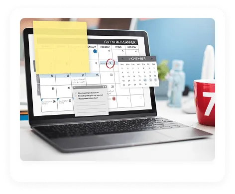 Laptop showing a calendar planner with a sticky note and reminder list, red mug beside it