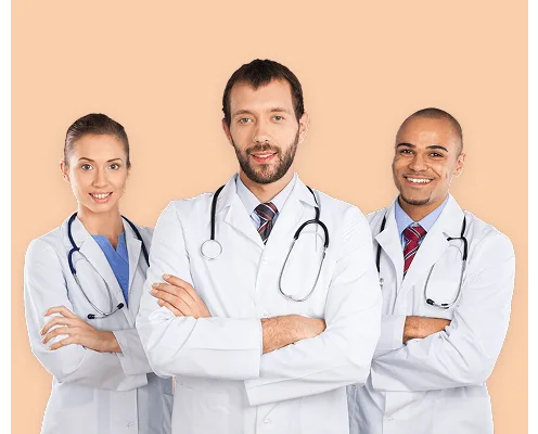 Three smiling doctors in white coats with stethoscopes, arms crossed, on a peach background