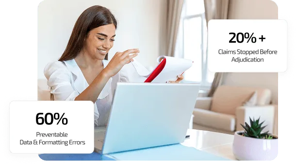 Smiling woman holding a document beside an open laptop in a bright living room