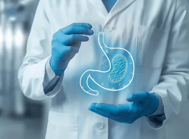 Gloved hands in a white coat holding a glowing illustrated stomach graphic