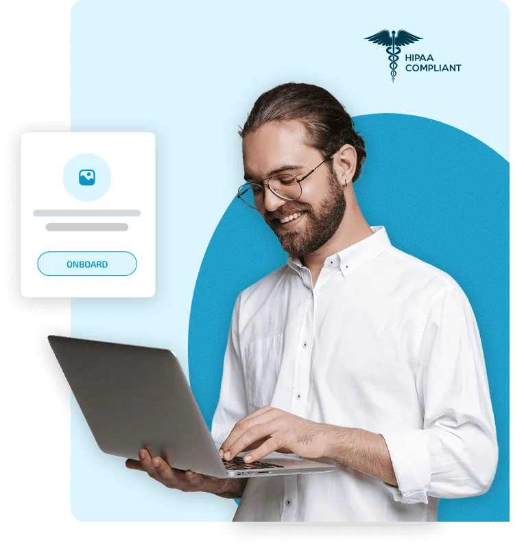 Smiling bearded man in glasses typing on a laptop beside an onboarding card