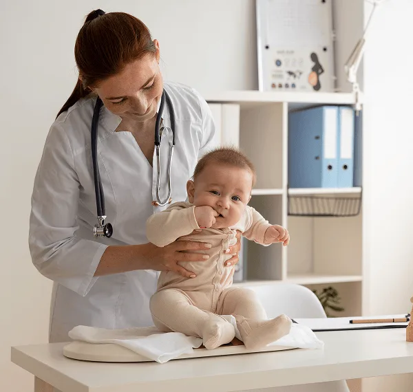 pediatric image 59486 webp Pediatrician in a white coat with a stethoscope holding an infant seated on a baby scale