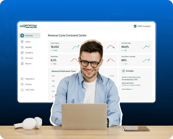 Smiling man with laptop in front of a revenue cycle dashboard with charts and sidebar menu