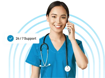 Smiling healthcare worker in blue scrubs with a stethoscope talking on a phone