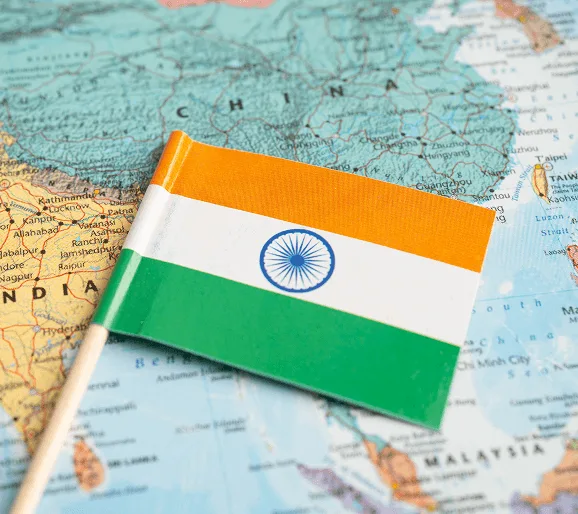 shared image 59289 webp Small Indian flag on a stick resting on a map of India and neighboring countries
